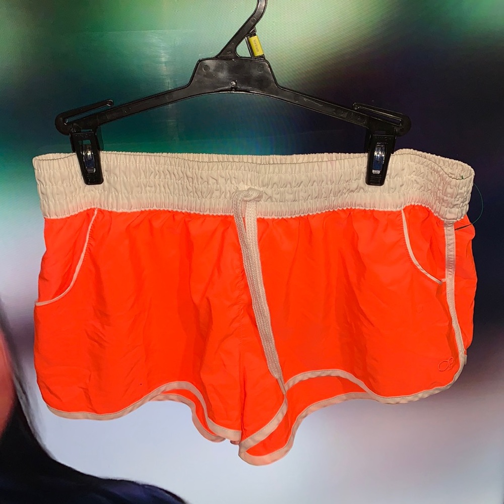 The color is bright Ember orange the brand is Op the size is L/G (11-13)